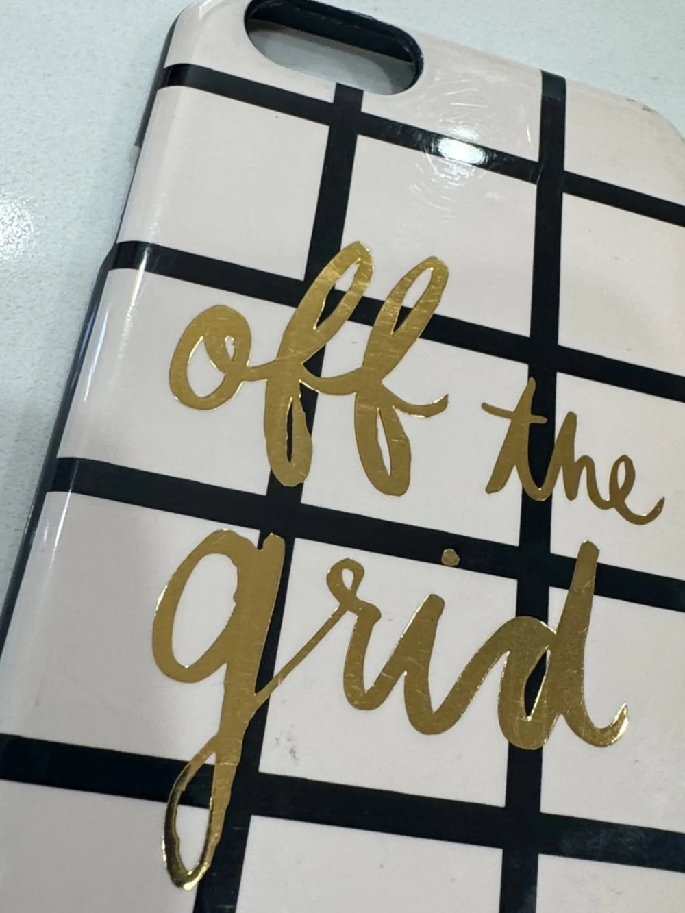 kate spade cream phone case with black grid and gold foil script